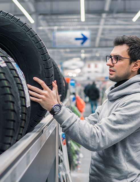 man shopping for tires