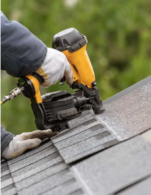 roofing contractor applying shingles