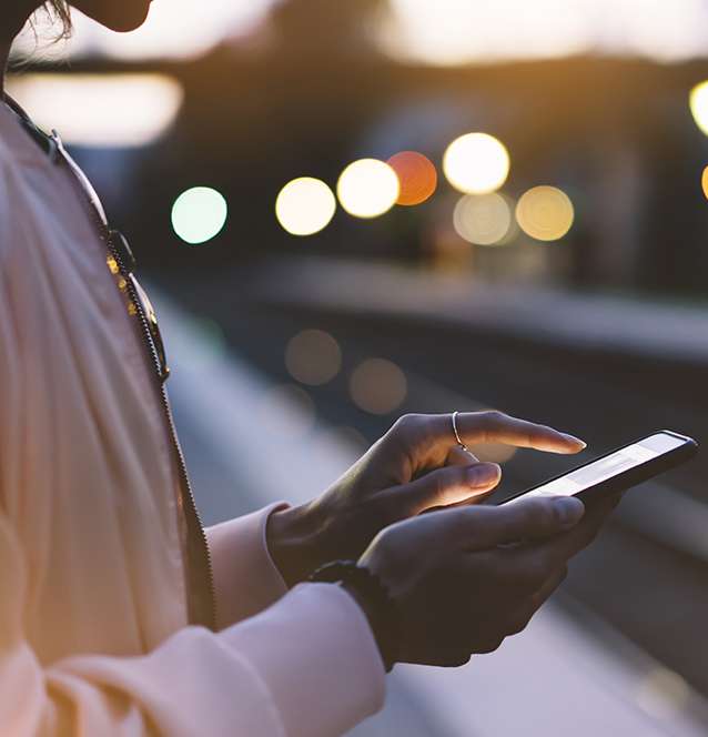 woman on a phone using the mobile version of ACB's online channel marketing hub
