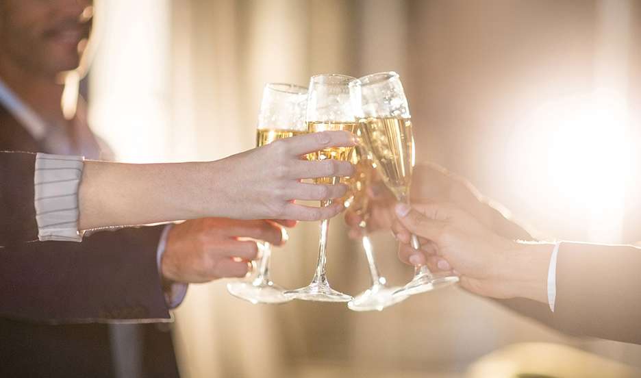 group of people toasting the 50th anniversary of ACB